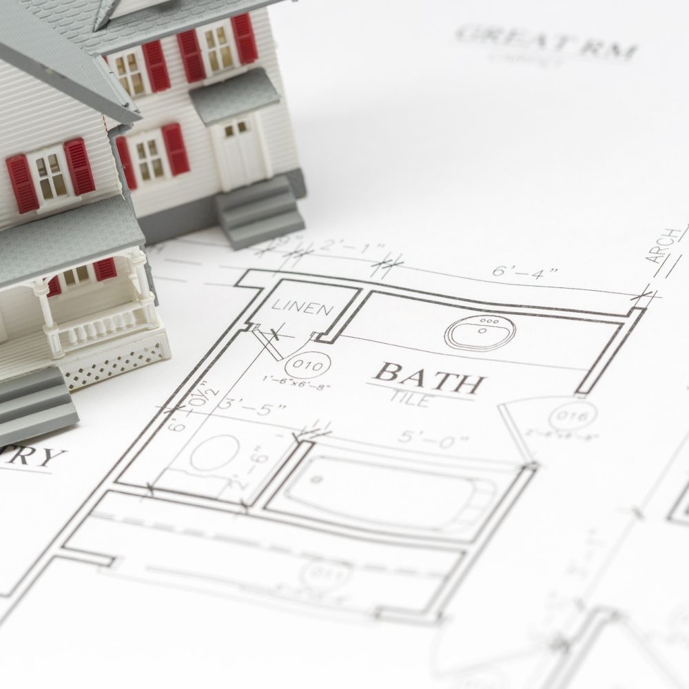 Model House Resting on Custom House Plans.